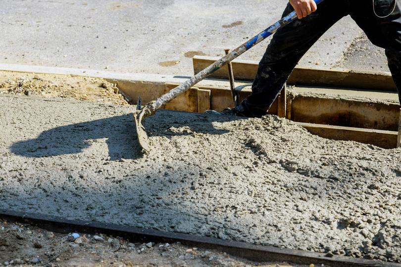 A high-rise building under construction with concrete being poured