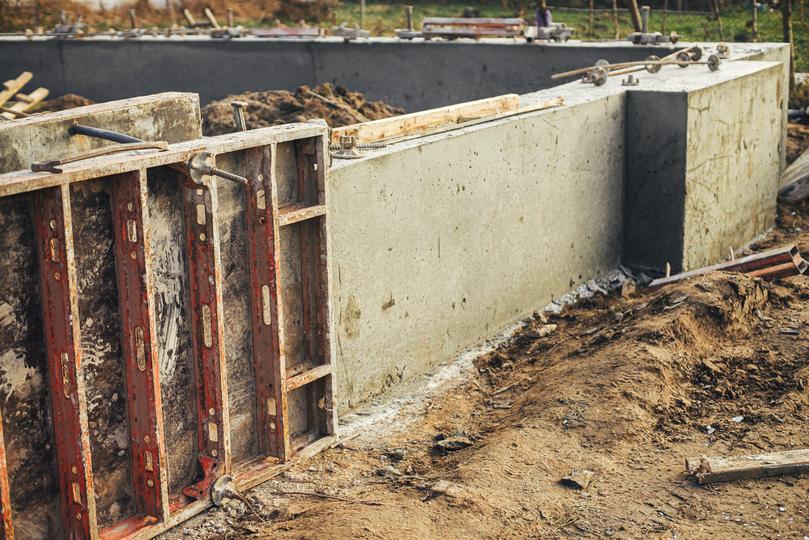 A concrete retaining wall in a landscaped garden