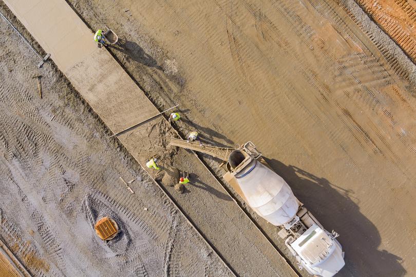 A Concrete truck pouring a foundation