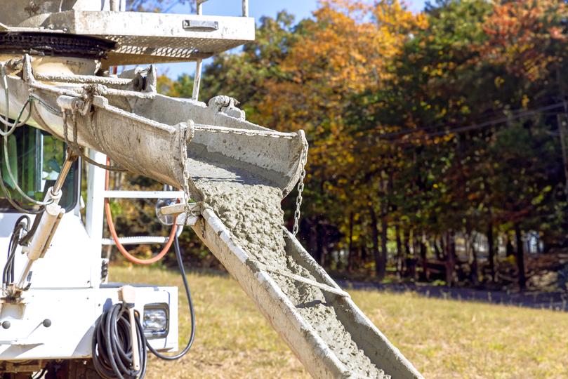 A Concrete truck pouring a foundation