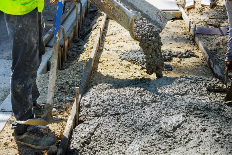 A Concrete truck pouring a foundation