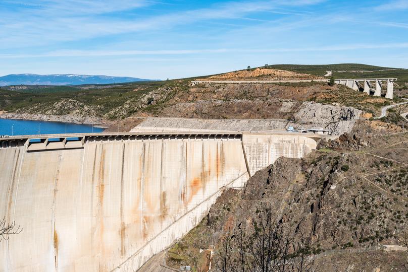 A concrete dam holding back a reservoir of water