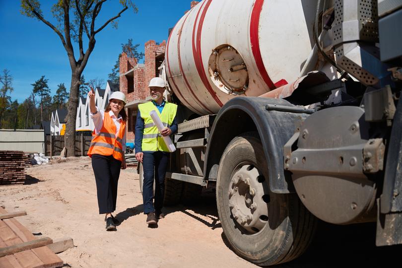 Volumetric concrete mixer preparing a custom mix on a construction site