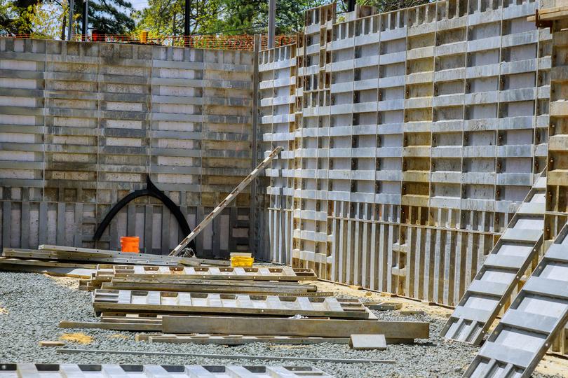 A concrete retaining wall in a landscaped garden