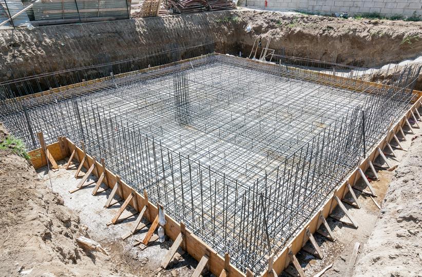A high-rise building under construction with concrete being poured