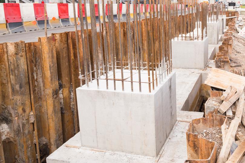 Construction workers pouring concrete for a foundation