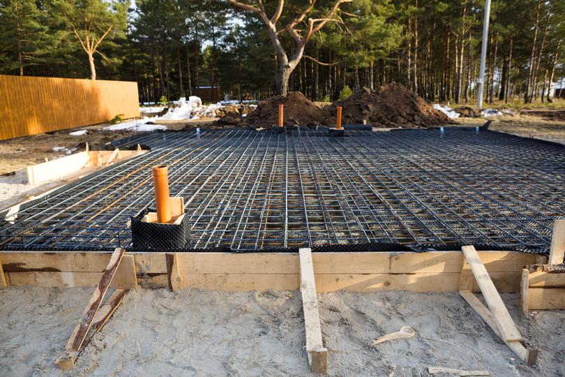 Construction workers pouring concrete for a foundation