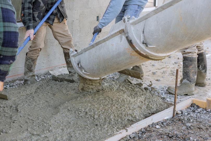 A Concrete truck pouring a foundation