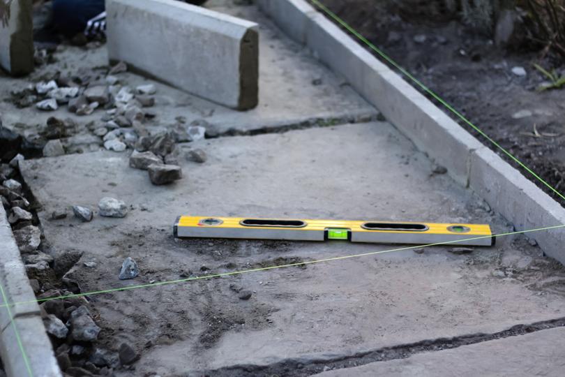 A newly installed concrete curb along a residential street