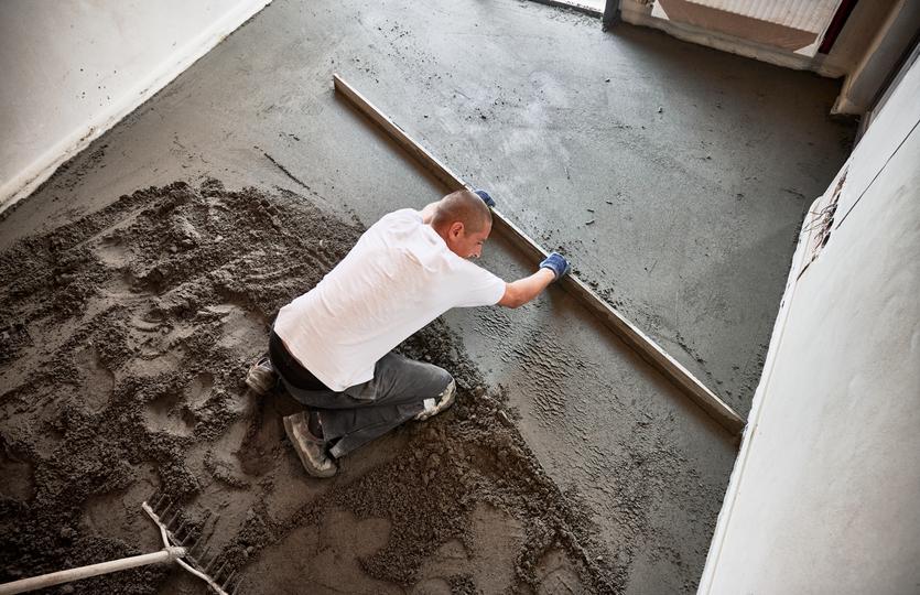 Professional screeding a concrete floor