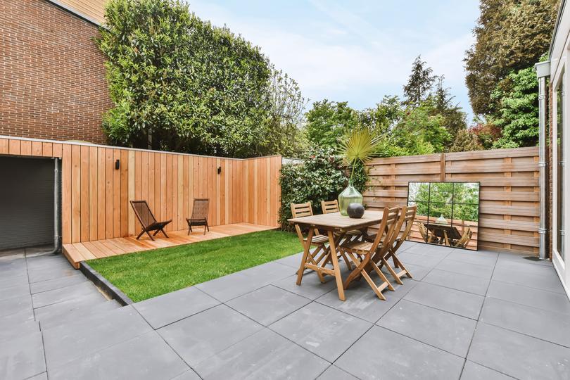 A modern concrete patio with stylish furniture