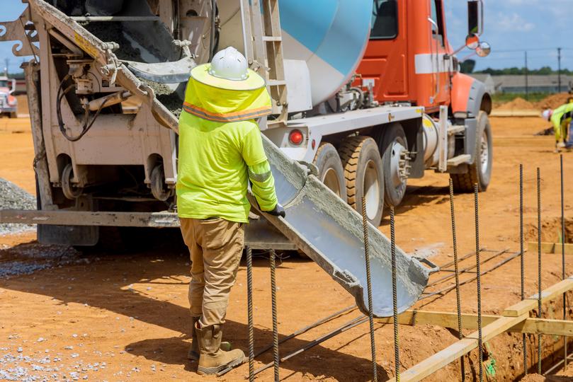 A Concrete truck pouring a foundation