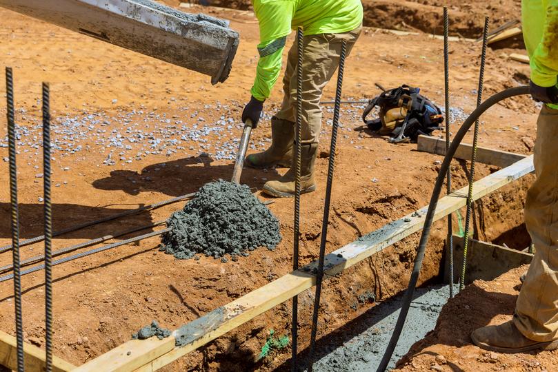 A Concrete truck pouring a foundation