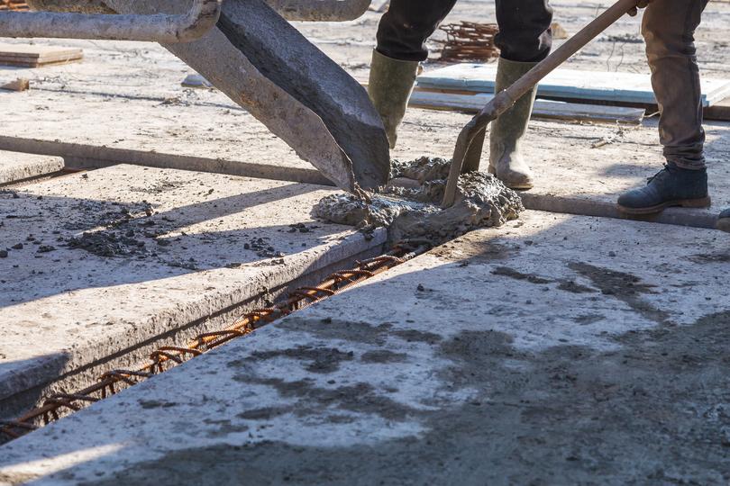 A Concrete truck pouring a foundation